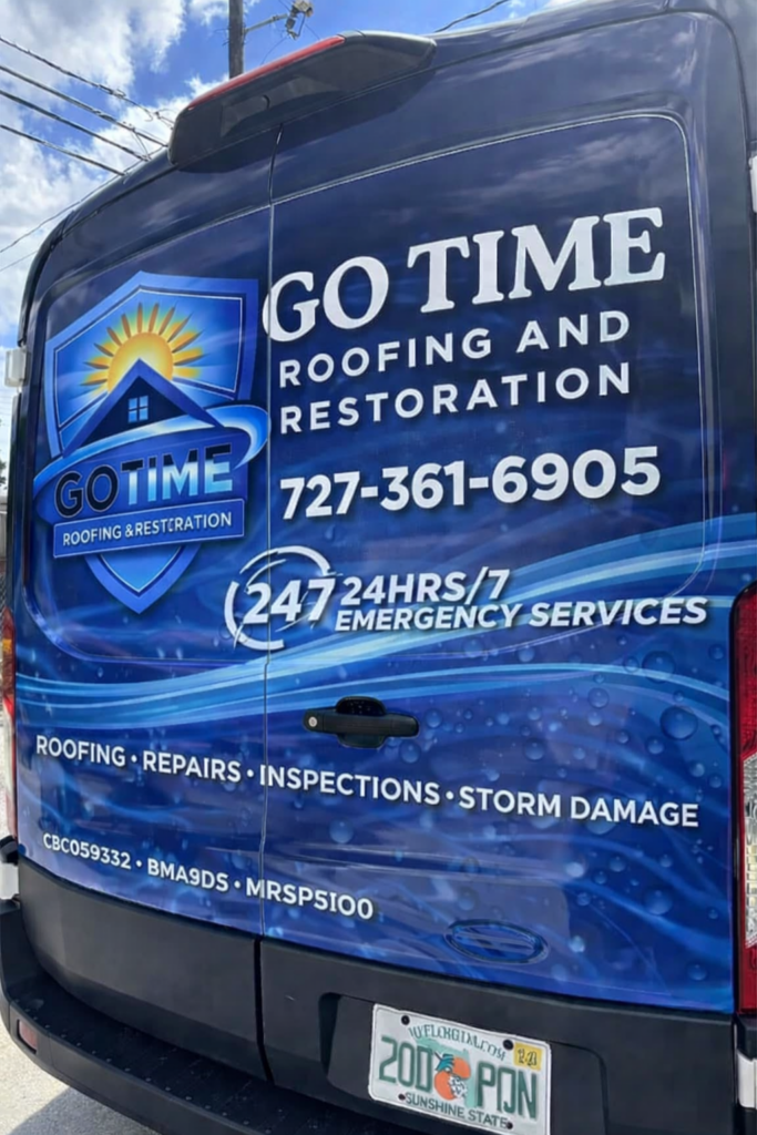 Rear view of a Go Time Roofing and Restoration van showcasing the company name, logo, phone number, emergency services, and Florida license plate. The About Us section highlights roofing, repairs, inspections, and storm damage services.