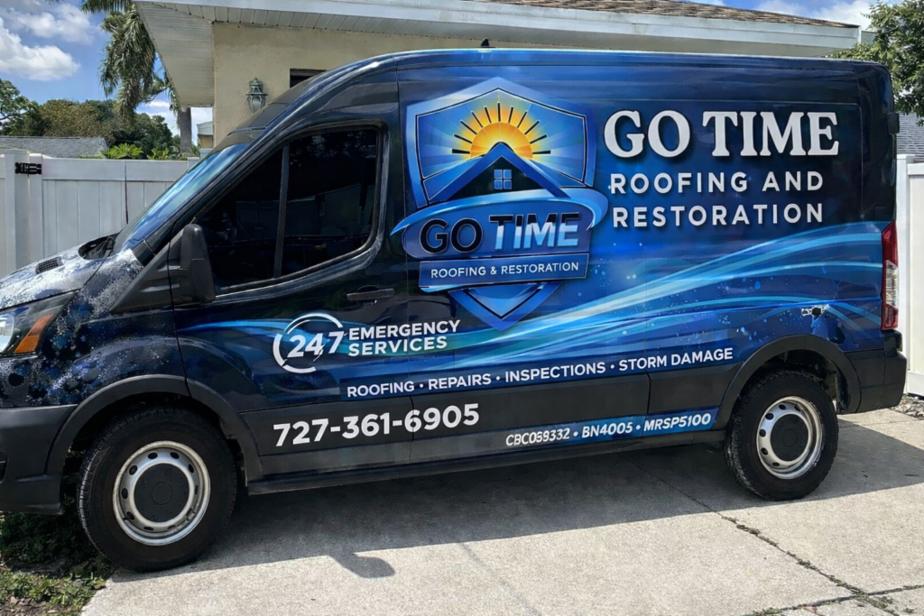 A blue van with "GO TIME Roofing and Restoration" and a sun logo on the side. The van advertises 24/7 emergency roofing services, repairs, inspections, storm damage, and a phone number: 727-361-6905.
